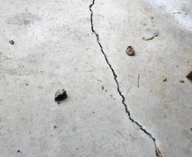 Close up of a floor crack in a garage.