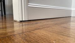 Close up of uneven and a bouncy floor in the interior of a home.