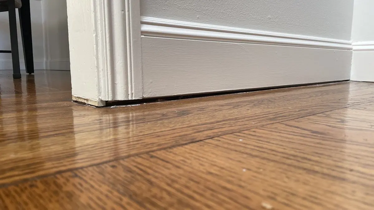 Close up of uneven and a bouncy floor in the interior of a home.