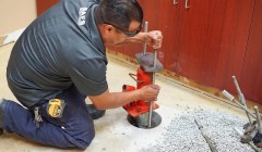 A worker completing a slab pier installation.