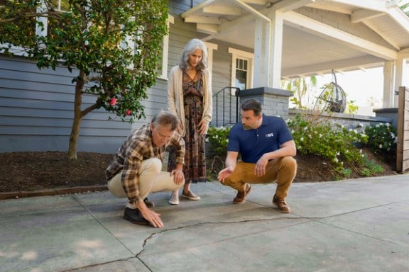Homeowners talk with Groundworks tech about the cracks in their concrete