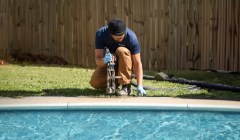 Groundworks tech repairing concrete on pool deck