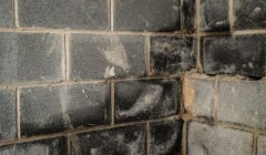 Close up of a wet basement wall.